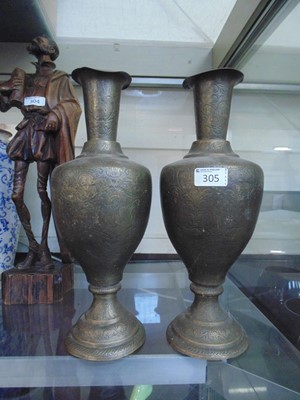 Lot 305 - A pair of eastern embossed brass urns