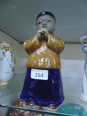 Lot 354 - An oriental ceramic figurine of young boy with...