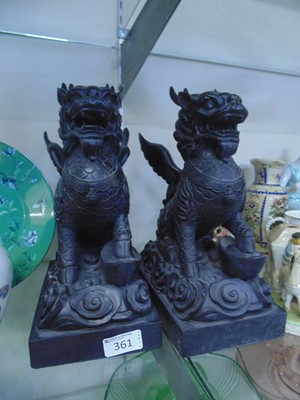 Lot 361 - A pair of black resin figures of dragons