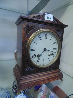 Lot 364 - A 20th century oak cased mantel clock on brass...