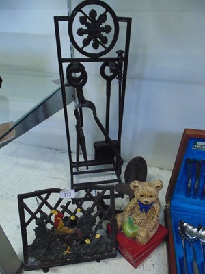 Lot 372 - A black cast metal companion stand with irons...