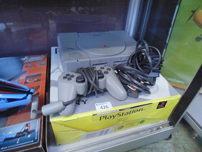 Lot 426 - A Sony Playstation with box and controller