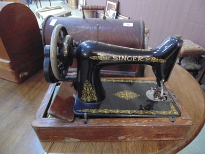 Lot 38 - An oak cased manual sewing machine