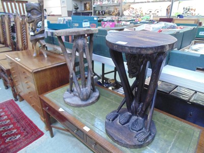 Lot 62 - A pair of African carved wooden stools with...