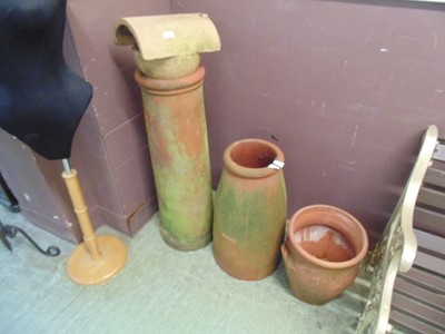 Lot 63 - A selection of clay pots and chimney pots to...