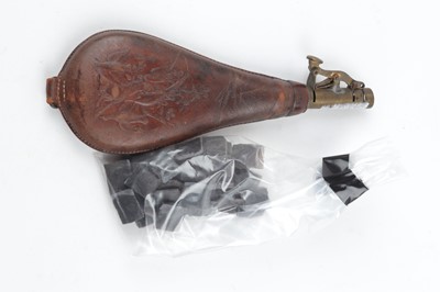 Lot 1025 - Bag of flints and a leather shot flask