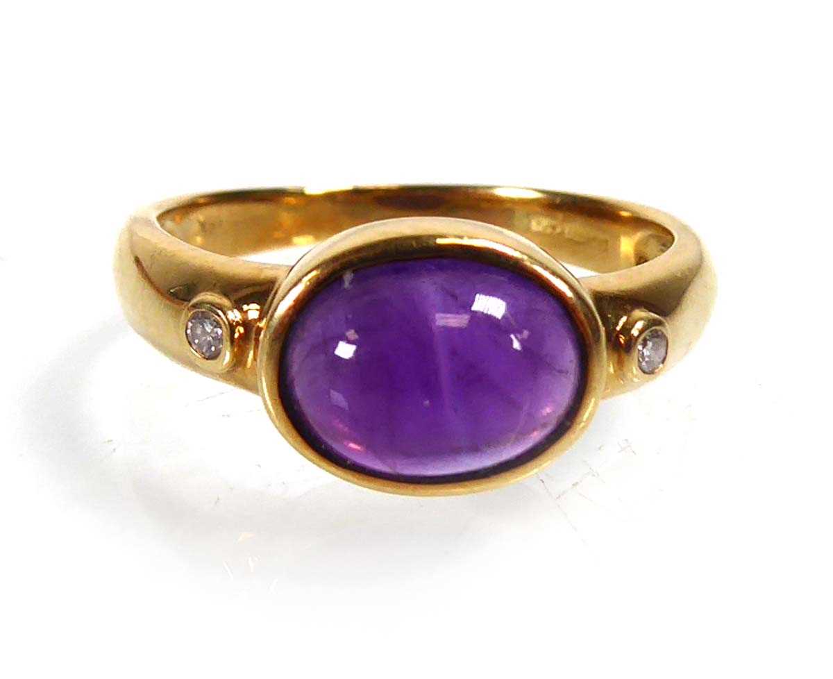 Lot An 18ct yellow gold ring set oval cabochon...