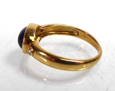 Lot An 18ct yellow gold ring set oval cabochon...