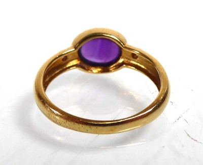 Lot An 18ct yellow gold ring set oval cabochon...