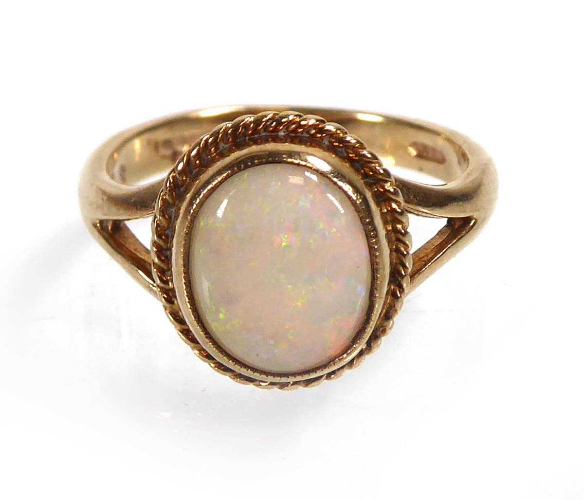 Lot A 9ct yellow gold ring set opal in a ropetwist...