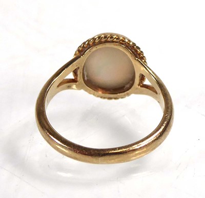 Lot A 9ct yellow gold ring set opal in a ropetwist...