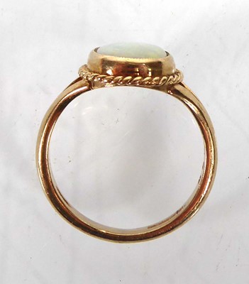 Lot A 9ct yellow gold ring set opal in a ropetwist...