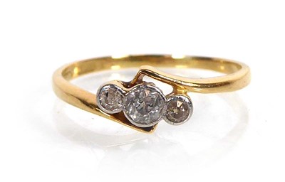 Lot An 18ct yellow gold crossover ring set three...