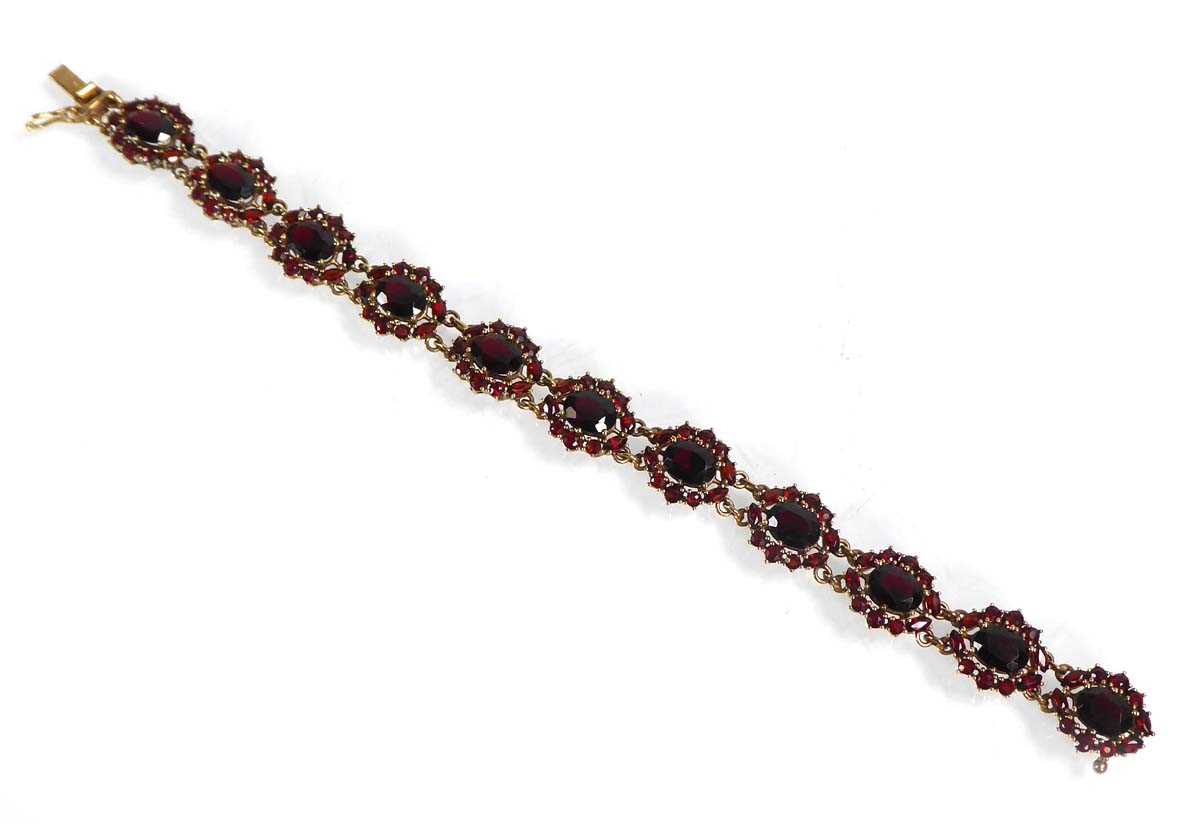 Lot A 9ct yellow gold bracelet set eleven garnet...