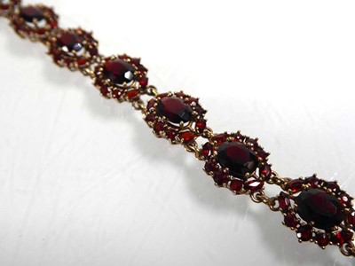 Lot A 9ct yellow gold bracelet set eleven garnet...