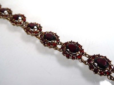 Lot A 9ct yellow gold bracelet set eleven garnet...