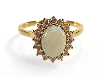 Lot An 18ct yellow gold cluster ring set oval opal...