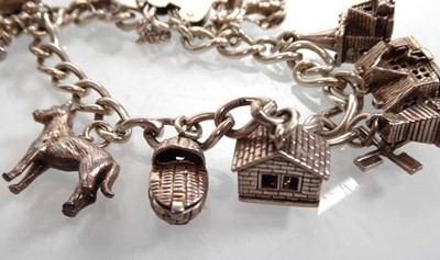 Lot A silver charm bracelet, a pair of silver...