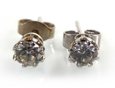 Lot A pair of 18ct white gold ear studs, each set...