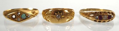 Lot An Edwardian 18ct yellow gold ring set three...