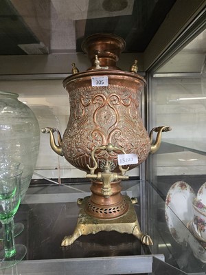 Lot 305 - An eastern embossed brass and copper samovar