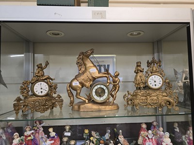 Lot 380 - Three gilted cast metal timepieces, one with...