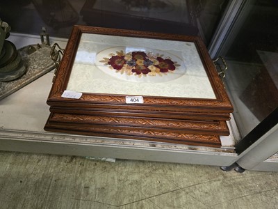 Lot 404 - Four carved wooden trays with encrusted floral...