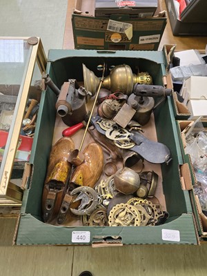 Lot 440 - A tray containing brass blow lamps, horse...