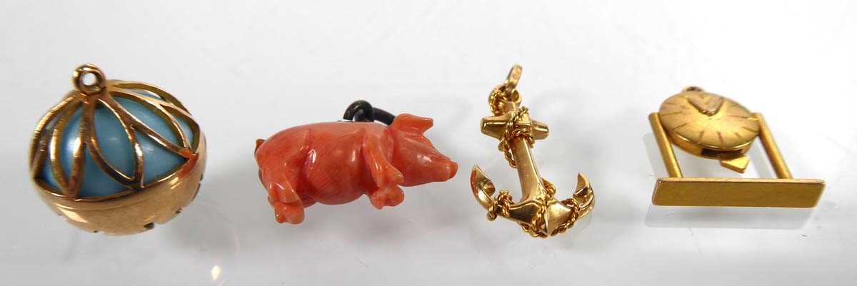 Lot Three yellow metal charms in the form of a...