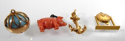 Lot Three yellow metal charms in the form of a...