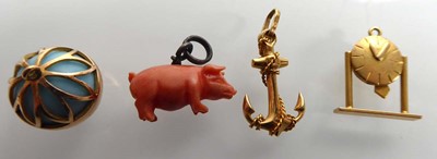 Lot Three yellow metal charms in the form of a...