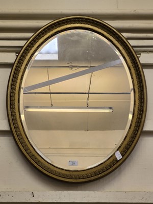 Lot 29 - A gilt painted ornate oval bevel glass wall...