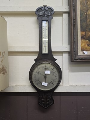 Lot 37 - An early 20th century carved oak banjo barometer