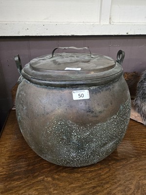 Lot 50 - A large copper lidded cauldron