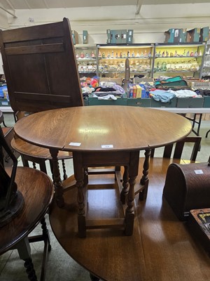 Lot 64 - A mid-20th century oak drop leaf table of...