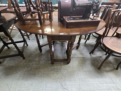 Lot 65 - A reproduction oak gate leg table