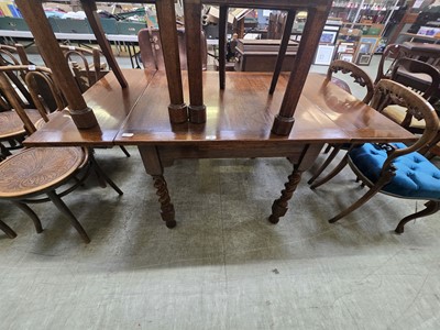 Lot 69 - A mid-20th century oak drawer leaf table on...