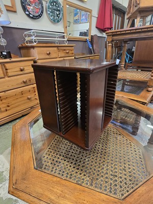 Lot 105 - A modern mahogany effect revolving CD storage...