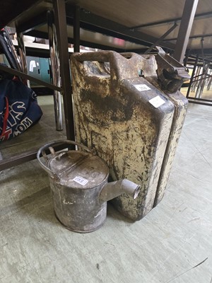 Lot 153 - A green distressed jerry can together with a...