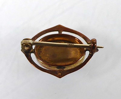 Lot A gilt metal Charles Horner brooch of oval...