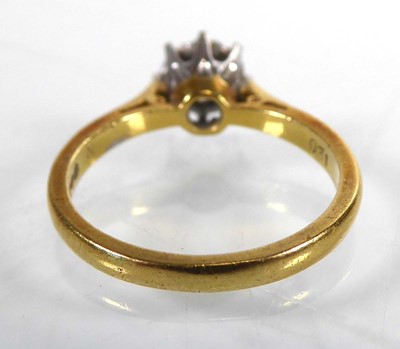 Lot An 18ct yellow gold ring set brilliant cut...