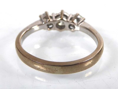 Lot An 18ct yellow gold ring set three graduated...