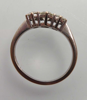 Lot An 18ct yellow gold ring set three graduated...