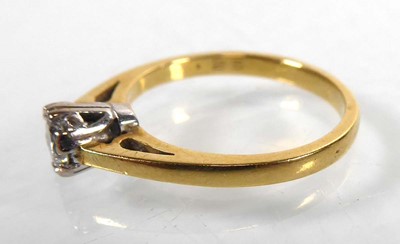 Lot An 18ct yellow gold ring set brilliant cut...