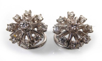 Lot A pair of 18ct white gold ear clips, each set...