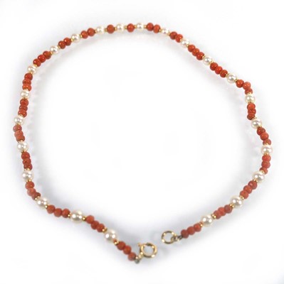 Lot A single strand coral and cultured pearl...