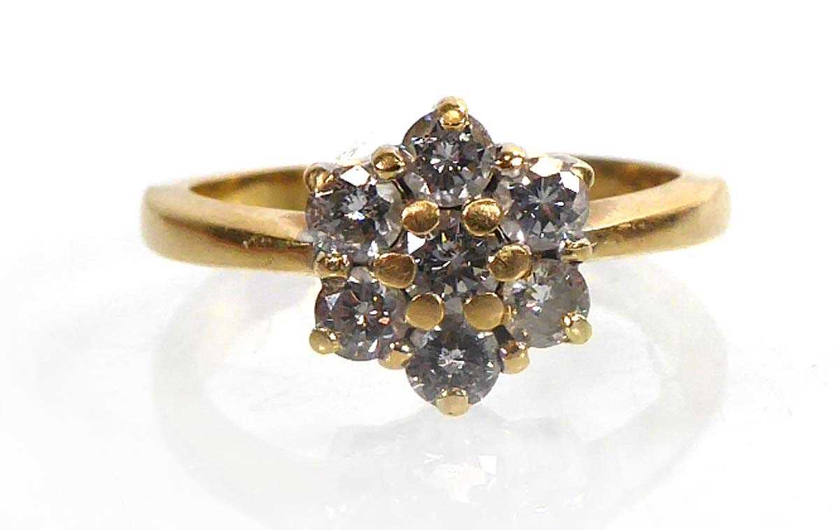 Lot 813 - An 18ct yellow gold cluster ring set seven...