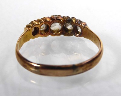 Lot An 18ct yellow gold ring set five graduated...