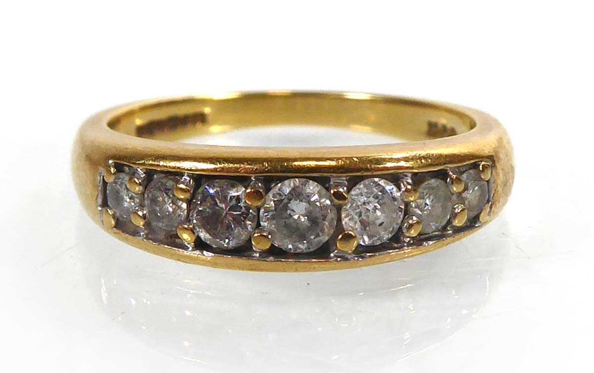 Lot 816 - An 18ct yellow gold ring set seven graduated...