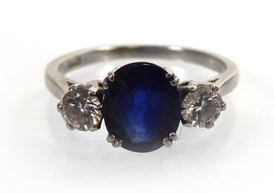 Lot A white metal ring set oval sapphire and two...